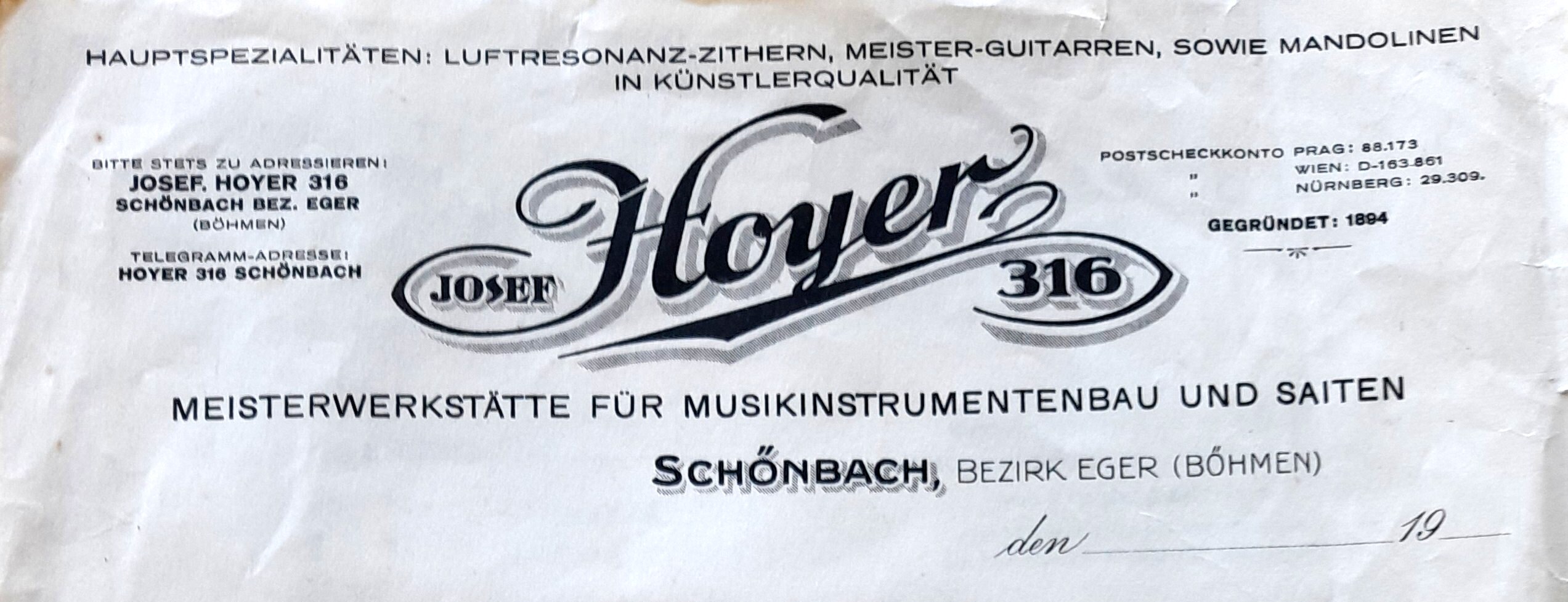 Crumpled white letterhead with an ornate JOSEF Hoyer 316 script logo, Schönbach near Eger address details, specialties in air-resonance zithers, master guitars and mandolins, and “Gegründet: 1894.”